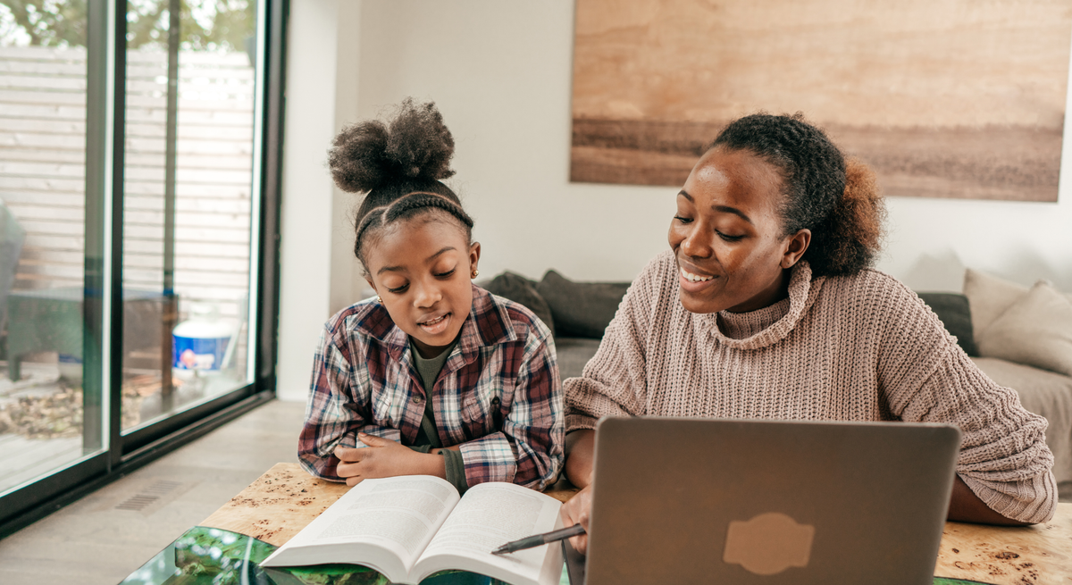 A mother and daughter reviewing Arkansas homeschool educational materials