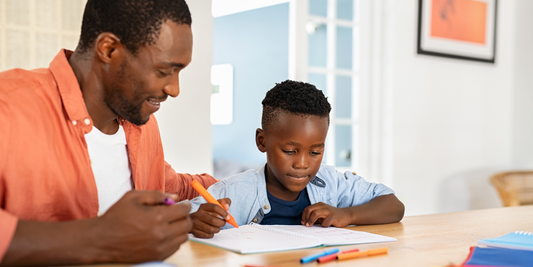 A father and son completing a homeschool assignment together, representing Missouri families using the MOScholars program to pay for homeschool costs.