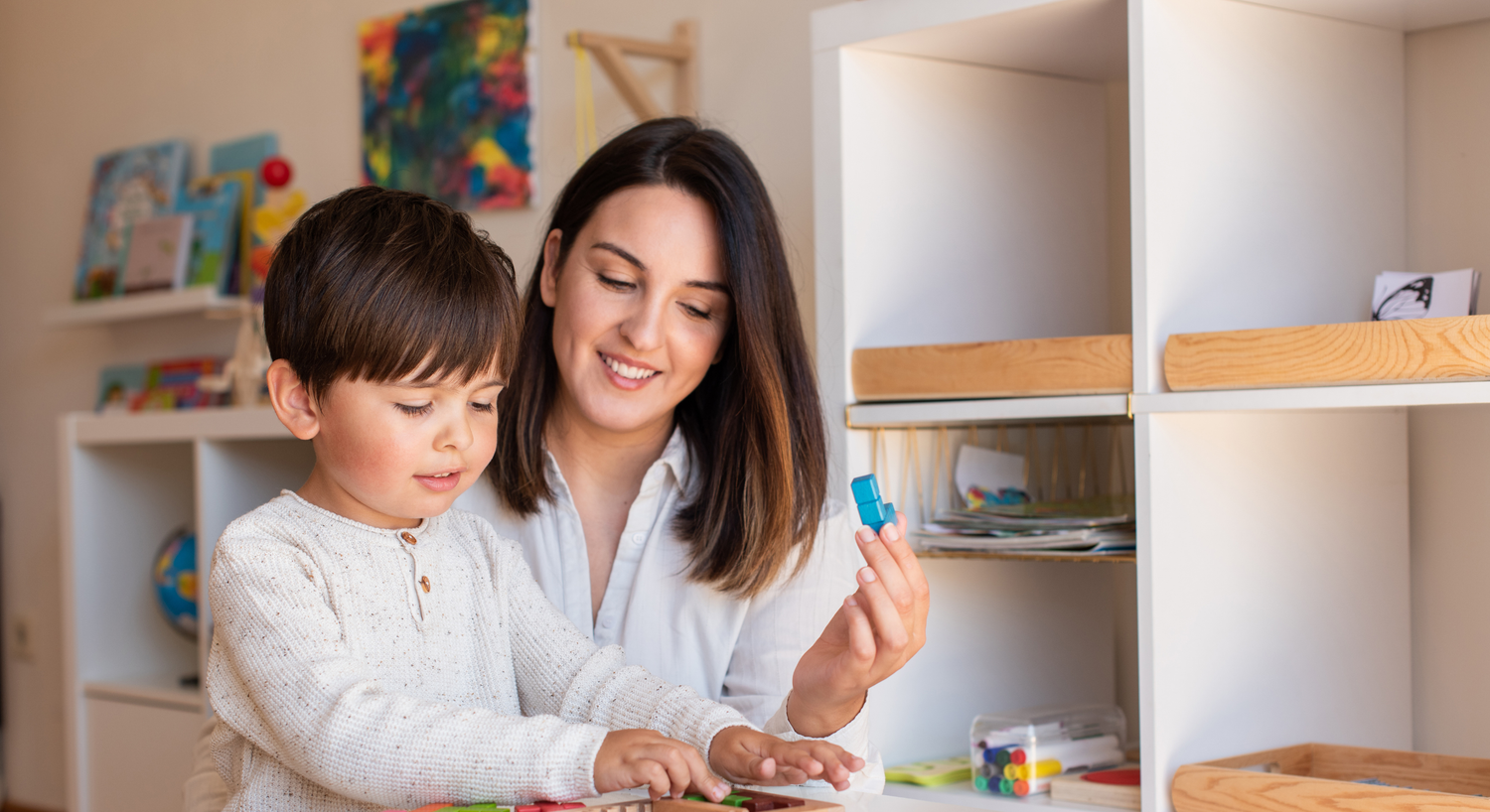 A parent and child work together on a homeschool project.
